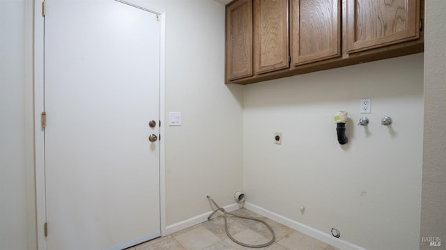 washroom with cabinet space, baseboards, hookup for a gas dryer, hookup for an electric dryer, and washer hookup