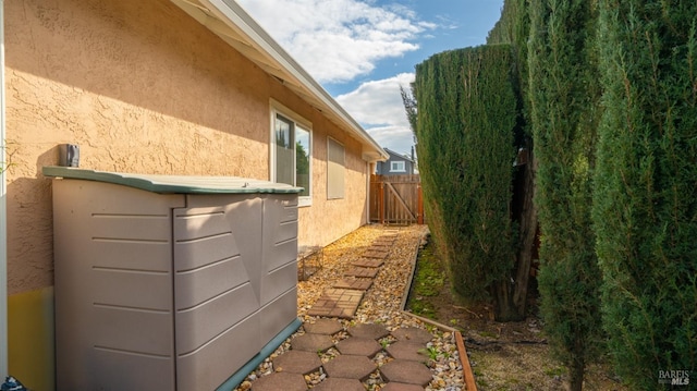view of property exterior featuring fence and stucco siding