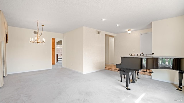 living area with light carpet, visible vents, a chandelier, and a textured ceiling