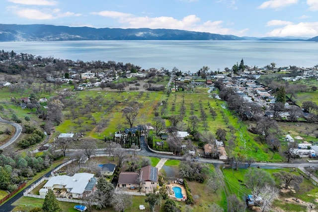 drone / aerial view with a water and mountain view