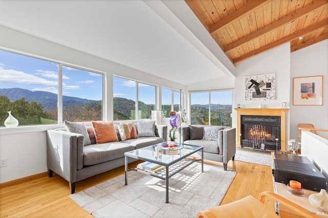 569 Sequoia Ave, San Anselmo, CA 94960 - living area with a mountain view, a warm lit fireplace, wood ceiling, light wood-style floors, and baseboards