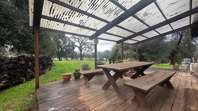 wooden deck featuring a yard and a pergola