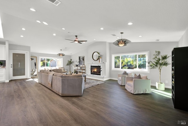 living room featuring ceiling fan, lofted ceiling, dark hardwood / wood-style floors, and a wealth of natural light