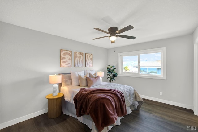 bedroom with ceiling fan and dark hardwood / wood-style flooring