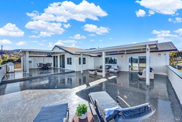 back of property with a patio area and outdoor lounge area