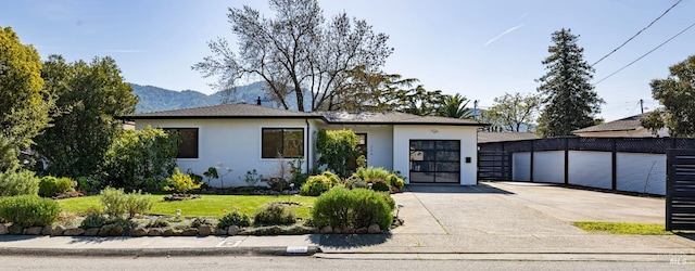 view of front of house with a mountain view and a front yard