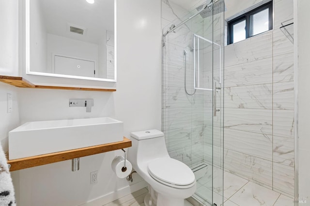 bathroom with toilet and an enclosed shower