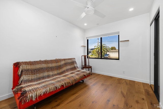 living area featuring ceiling fan and wood-type flooring