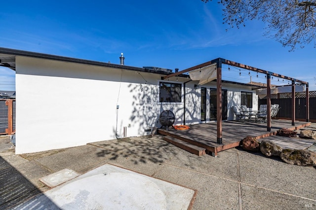 exterior space featuring a wooden deck and a patio area