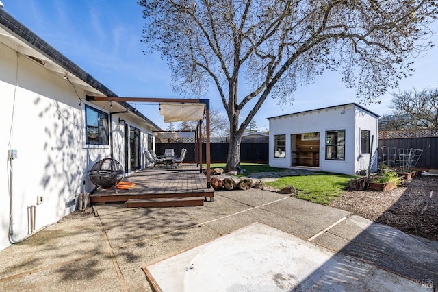 view of patio with an outbuilding and a deck