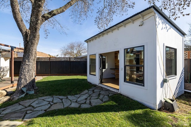 rear view of property with a lawn