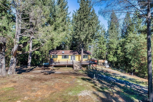 back of house featuring a wooden deck