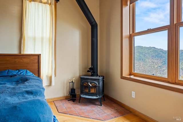 bedroom featuring a mountain view and a wood stove