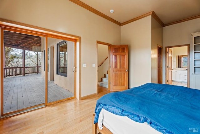 bedroom with light hardwood / wood-style flooring, a towering ceiling, access to exterior, ensuite bathroom, and ornamental molding