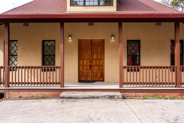 doorway to property featuring covered porch