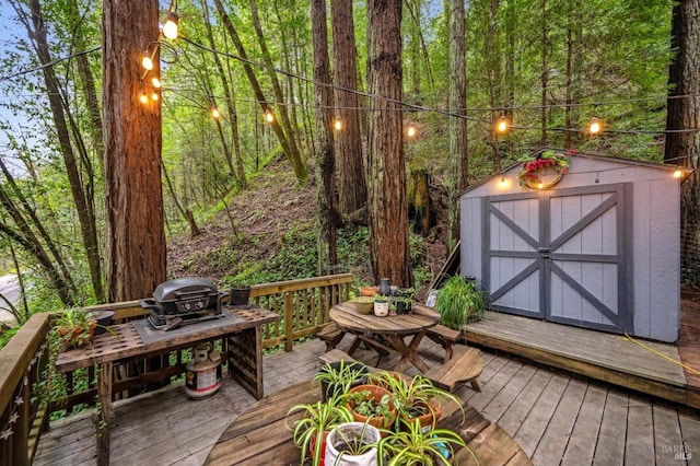 deck with a shed and grilling area