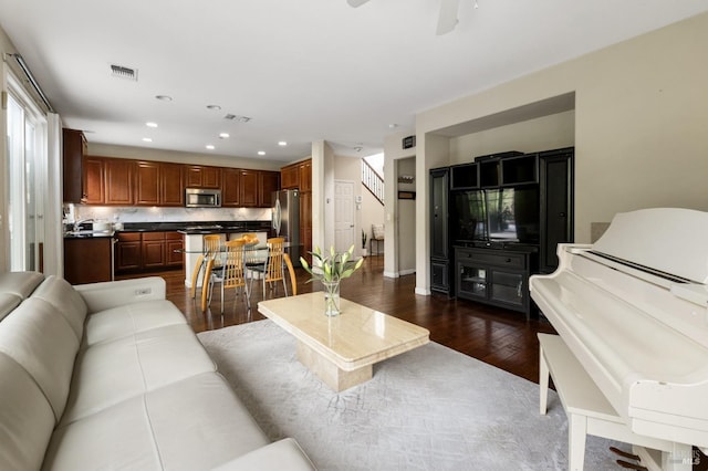 living area featuring ceiling fan, visible vents, dark wood finished floors, and recessed lighting