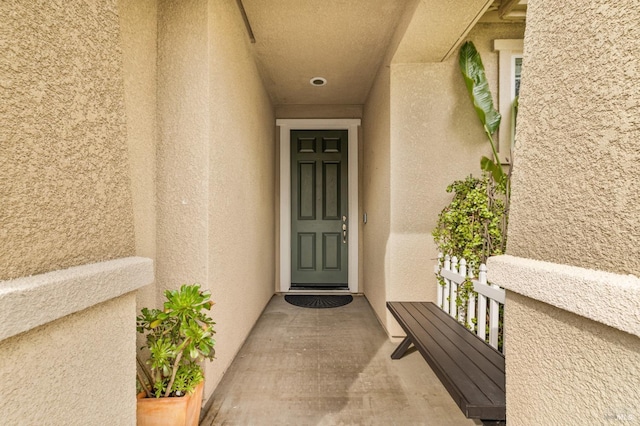 view of exterior entry featuring stucco siding