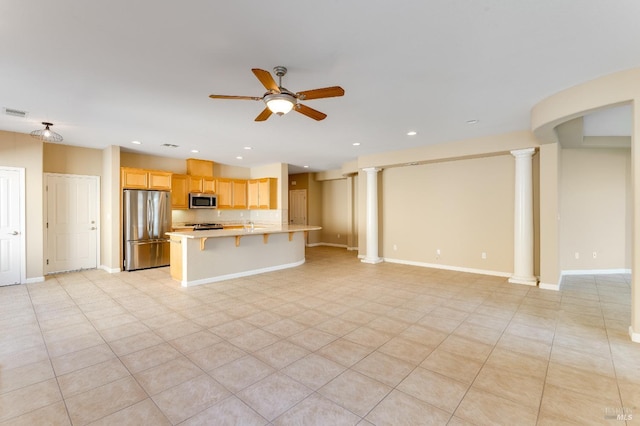 unfurnished living room featuring a ceiling fan, decorative columns, and recessed lighting