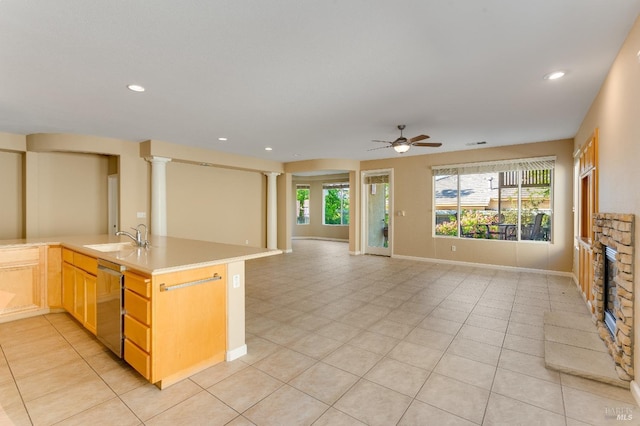 kitchen with a ceiling fan, recessed lighting, light tile patterned floors, a sink, and dishwasher