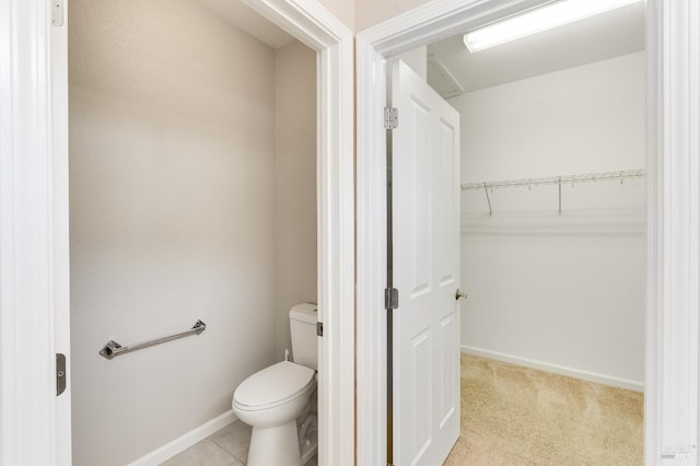 bathroom featuring baseboards and toilet