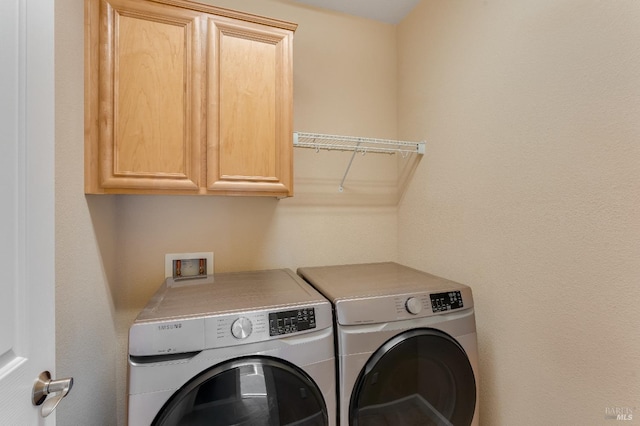 laundry room with cabinet space and washer and dryer