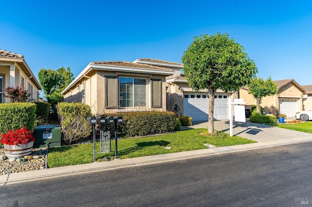 view of front of property featuring a front lawn, stucco siding, a tile roof, and concrete driveway