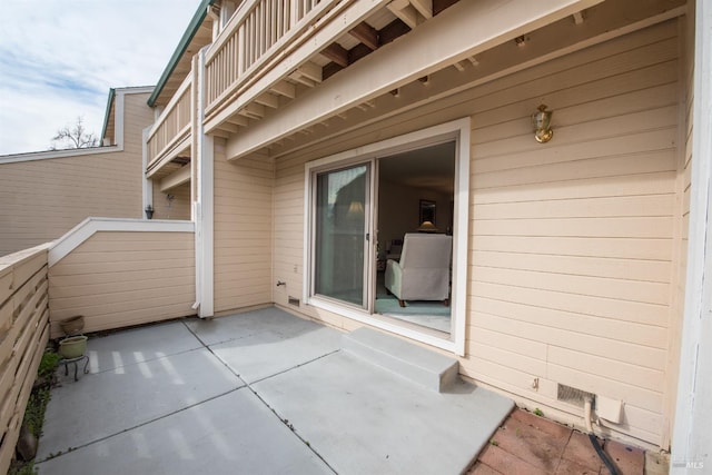 view of patio featuring a balcony