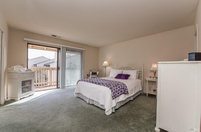 bedroom featuring visible vents, dark carpet, and access to outside