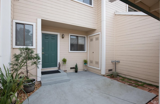 view of exterior entry featuring a patio