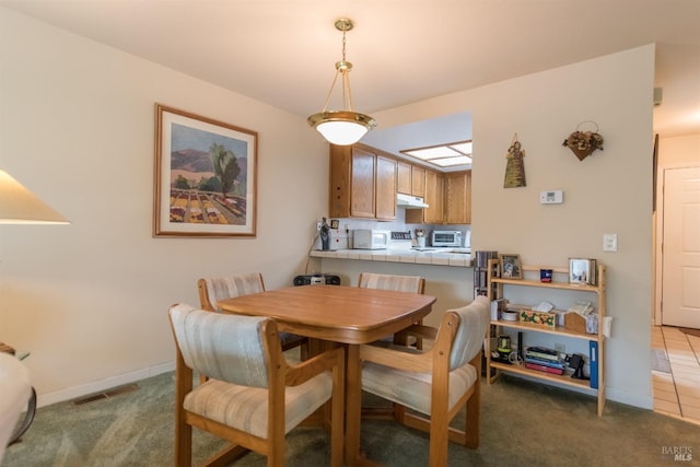 dining area featuring baseboards, carpet floors, and visible vents
