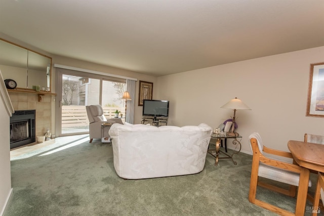 carpeted living area featuring a tiled fireplace