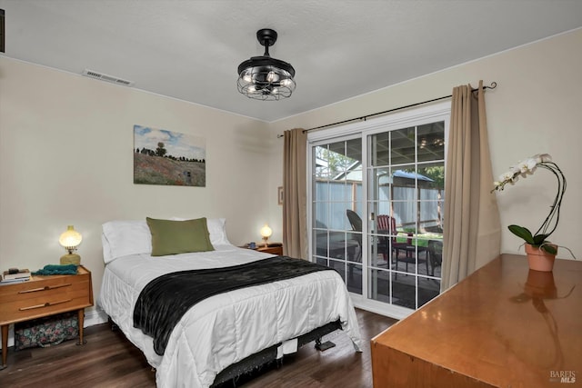 bedroom featuring access to exterior and dark hardwood / wood-style floors