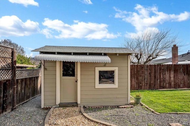 view of outbuilding with a yard