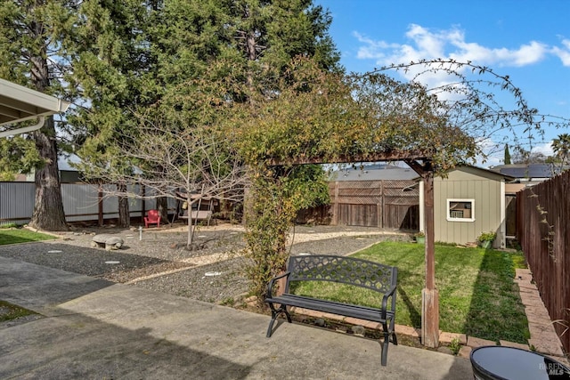 view of yard featuring a storage unit and a patio