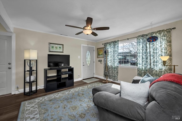 living room featuring ceiling fan, ornamental molding, and dark hardwood / wood-style flooring