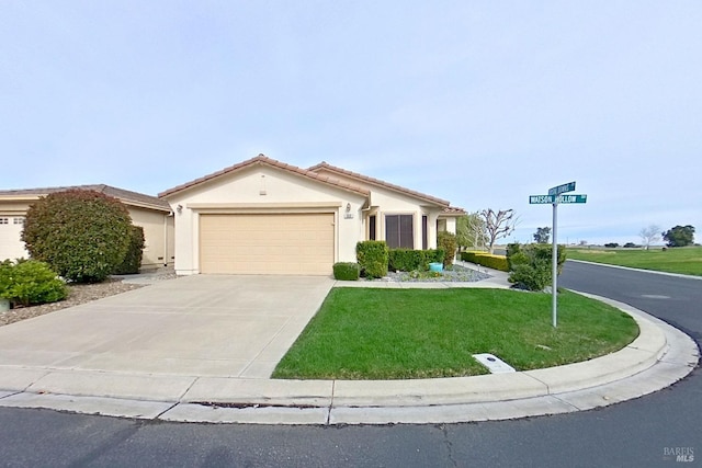 view of front of property featuring a garage and a front yard