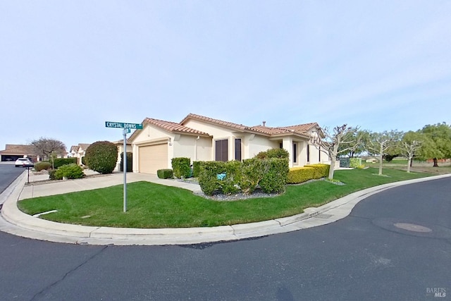 view of front of property featuring a garage and a front lawn