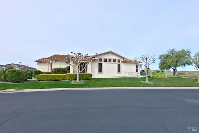 mediterranean / spanish-style house featuring a front yard