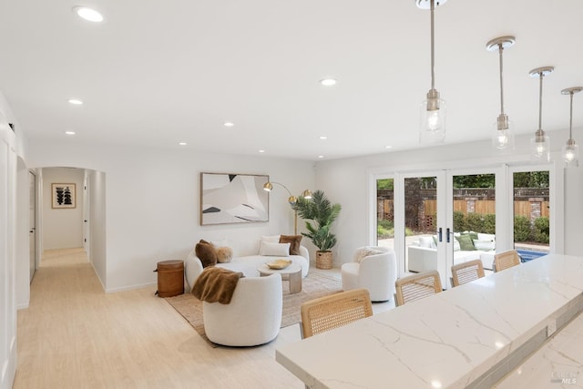 living room with french doors and light wood-type flooring