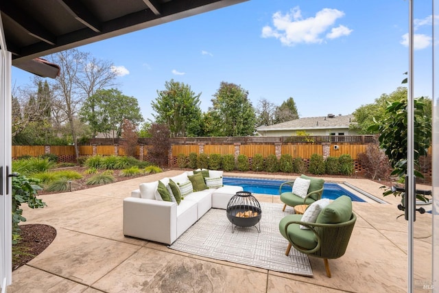 view of patio featuring a fenced in pool and an outdoor living space with a fire pit