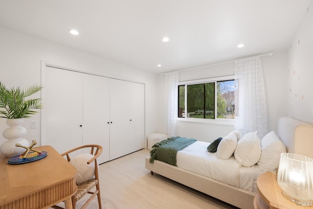 bedroom with light hardwood / wood-style flooring and a closet