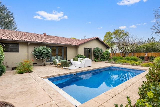 view of swimming pool with french doors, an outdoor living space, and a patio