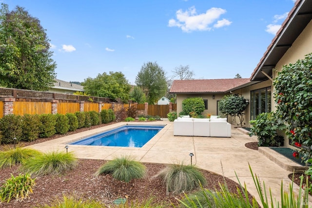 view of swimming pool featuring an outdoor living space and a patio area