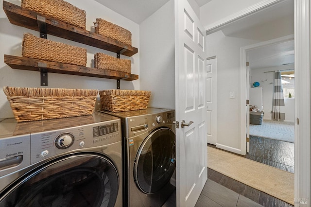 laundry room with dark hardwood / wood-style floors and washer and clothes dryer