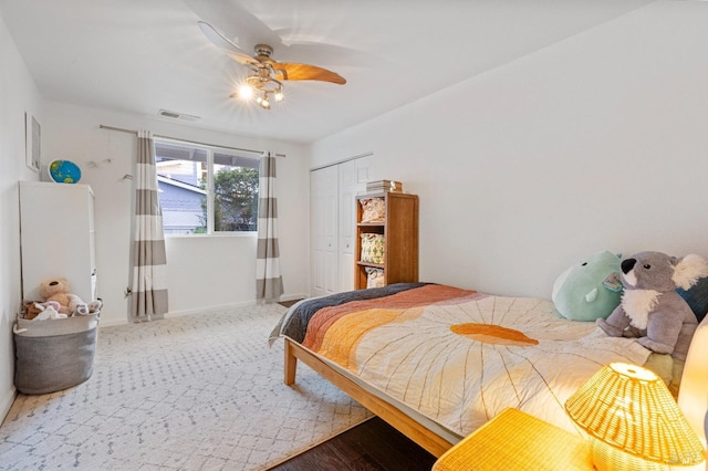 bedroom featuring ceiling fan and a closet