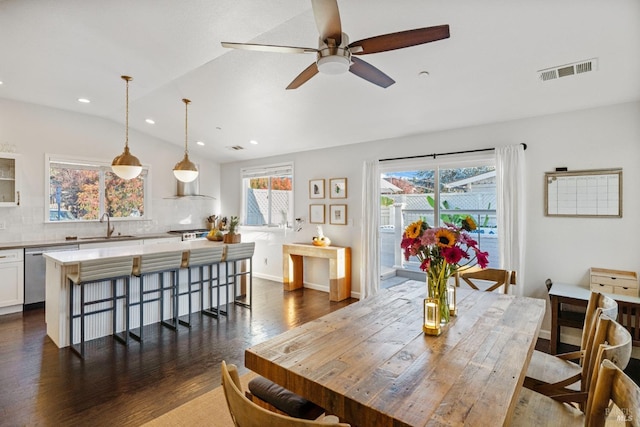 dining area with sink, vaulted ceiling, dark hardwood / wood-style floors, and ceiling fan