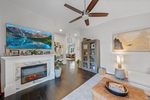 living room with vaulted ceiling, dark hardwood / wood-style floors, ceiling fan, and a fireplace