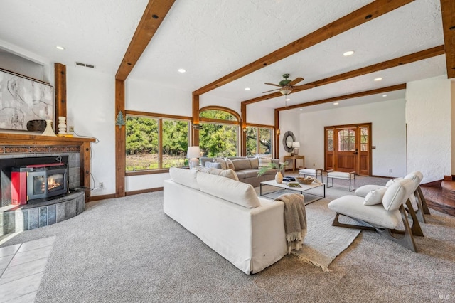 living room featuring beamed ceiling, plenty of natural light, and a textured ceiling