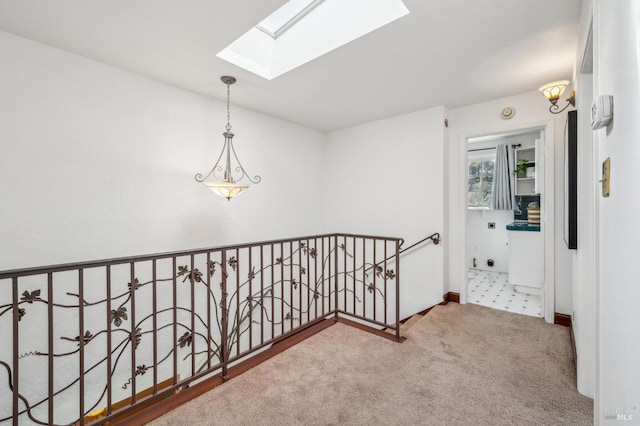 corridor featuring carpet flooring and a skylight